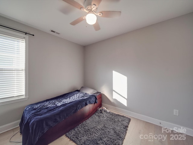 bedroom featuring ceiling fan and light hardwood / wood-style flooring