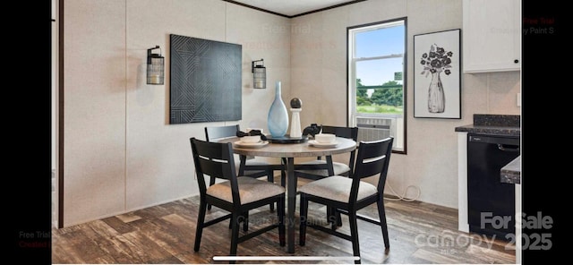 dining room with crown molding and dark wood-type flooring