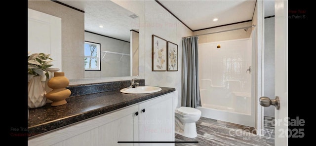 full bathroom with vanity, toilet, shower / bath combo, and a textured ceiling