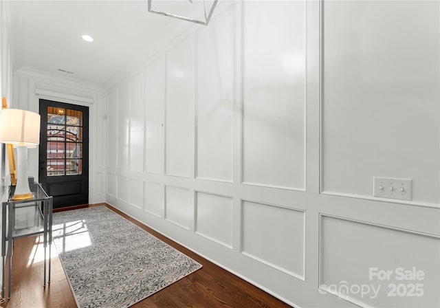 hall featuring dark hardwood / wood-style flooring and ornamental molding