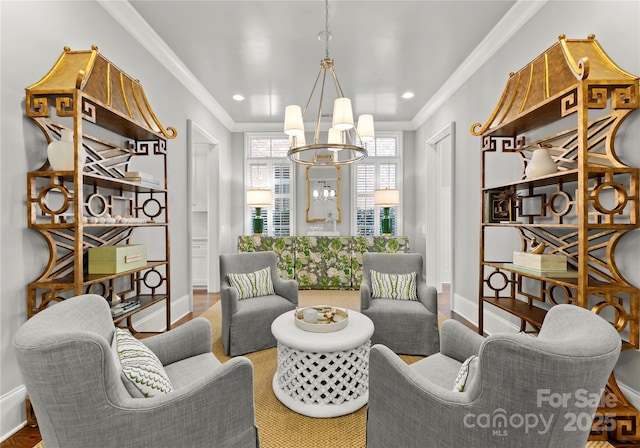 sitting room featuring crown molding and a chandelier