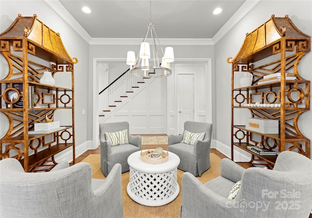 interior space featuring an inviting chandelier, crown molding, and hardwood / wood-style floors