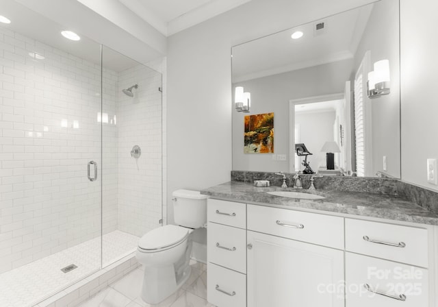 bathroom featuring an enclosed shower, vanity, toilet, and crown molding