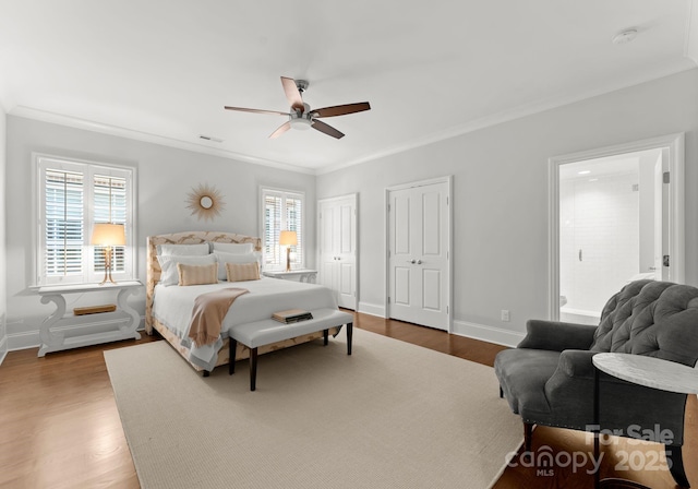 bedroom featuring ceiling fan, ornamental molding, hardwood / wood-style flooring, and multiple windows