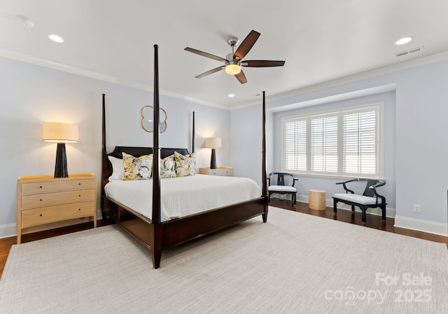 bedroom featuring ceiling fan, ornamental molding, and wood-type flooring