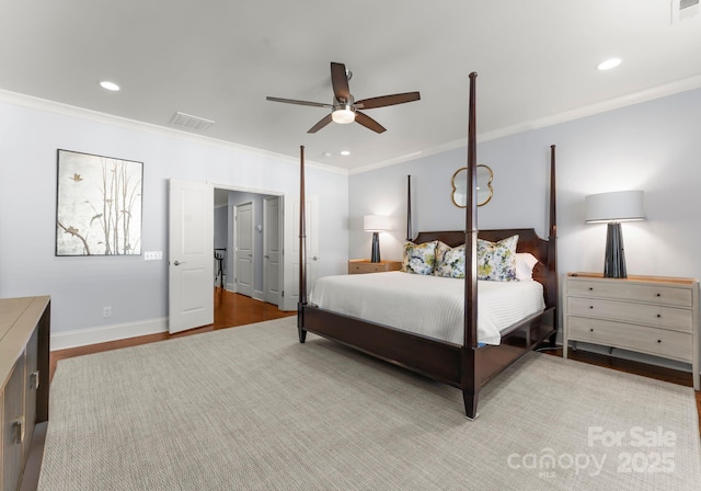 bedroom featuring ceiling fan, crown molding, and light hardwood / wood-style flooring