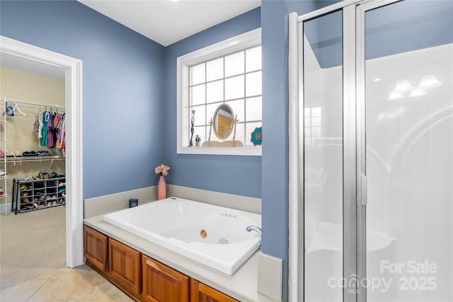 bathroom featuring separate shower and tub and tile patterned flooring