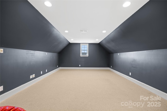 additional living space featuring carpet flooring and lofted ceiling