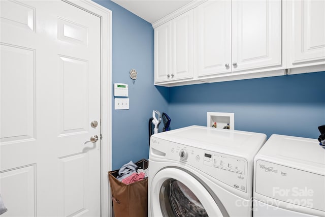 laundry area featuring cabinets and separate washer and dryer