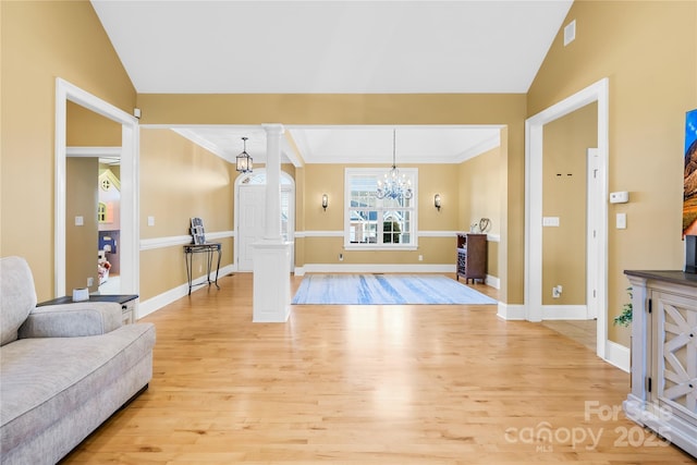 interior space with light wood-type flooring, ornate columns, and lofted ceiling