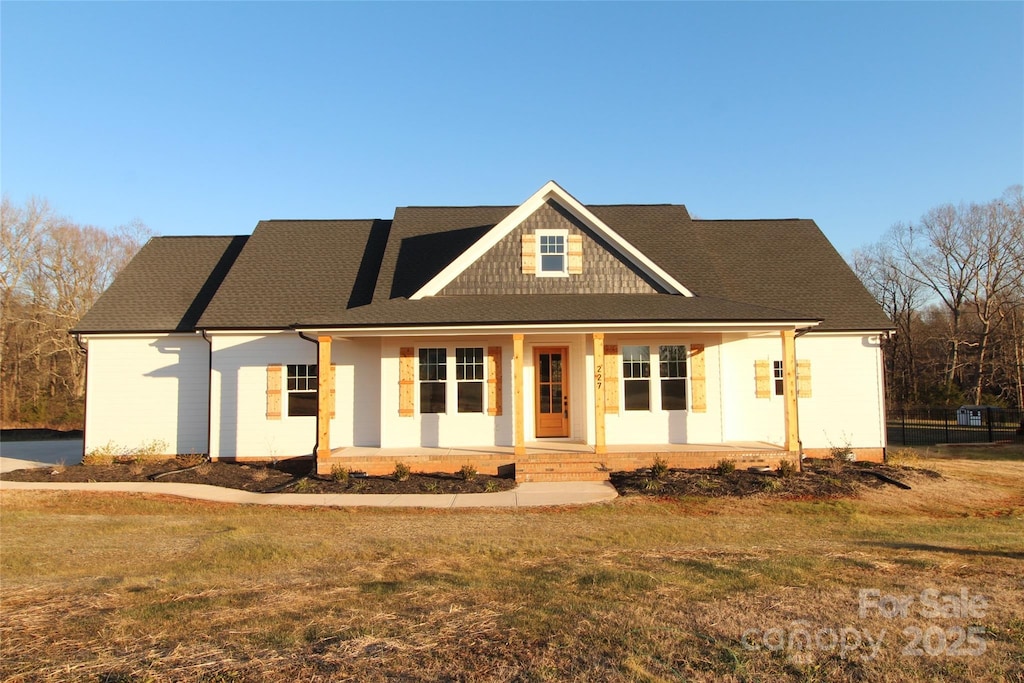 view of front of property with a front yard and a porch