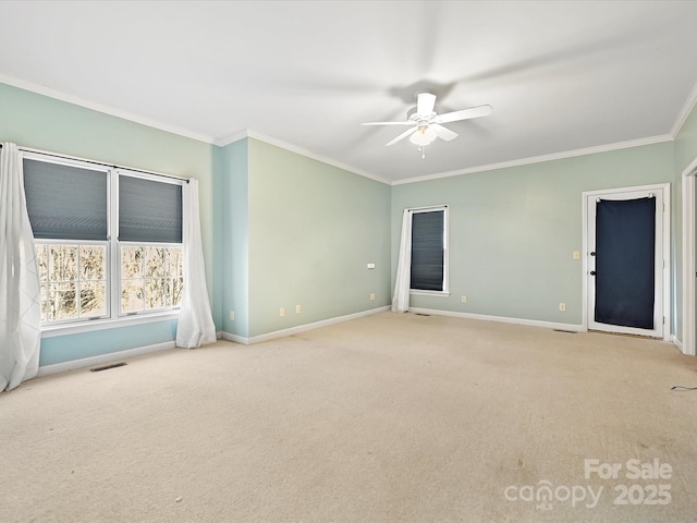 spare room featuring crown molding, visible vents, light carpet, ceiling fan, and baseboards