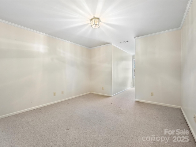 spare room featuring light carpet, baseboards, visible vents, and crown molding