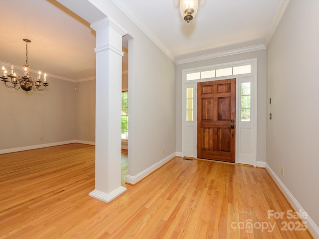 foyer with light wood finished floors, a notable chandelier, and a healthy amount of sunlight