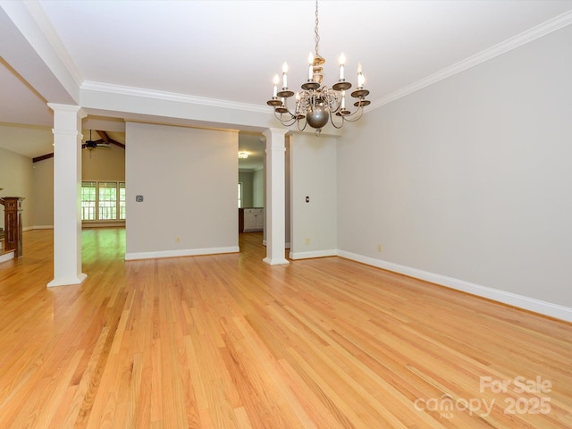 spare room with ceiling fan with notable chandelier, decorative columns, light wood-style floors, and ornamental molding