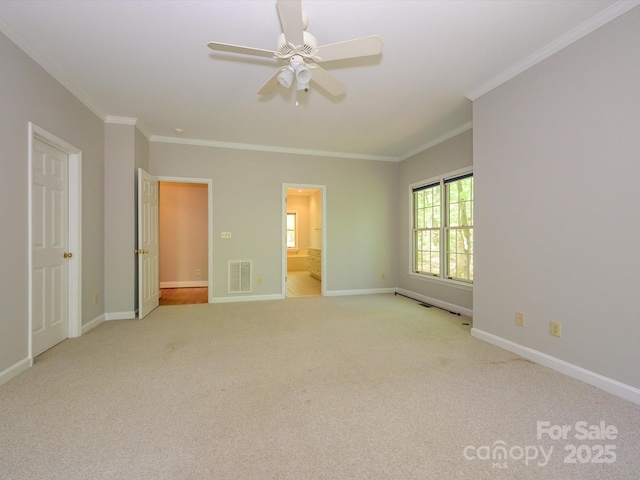 unfurnished bedroom featuring carpet floors, crown molding, visible vents, and baseboards