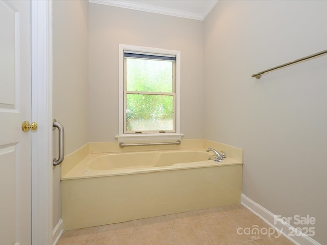 full bathroom featuring a bath, tile patterned floors, baseboards, and ornamental molding
