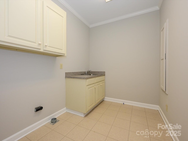 washroom featuring baseboards, crown molding, and a sink