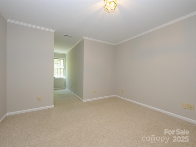 unfurnished room with light carpet, crown molding, visible vents, and baseboards