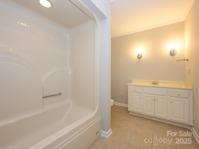 bathroom featuring toilet, baseboards, tile patterned flooring, vanity, and ornamental molding