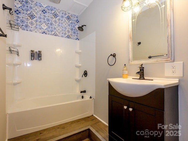 full bathroom featuring baseboards, bathing tub / shower combination, wood finished floors, and vanity