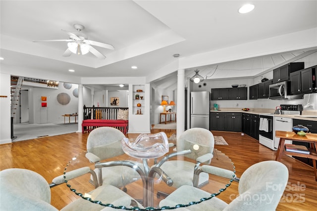 dining space featuring light wood-type flooring, ceiling fan, and built in features