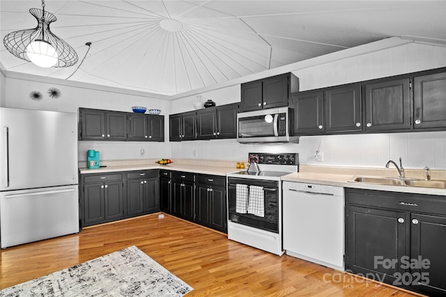 kitchen with sink, hanging light fixtures, light hardwood / wood-style flooring, and stainless steel appliances