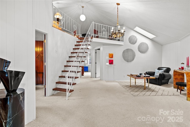 interior space featuring vaulted ceiling, an inviting chandelier, carpet, and wooden walls