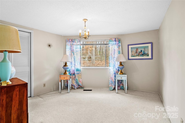 interior space with a textured ceiling and a chandelier