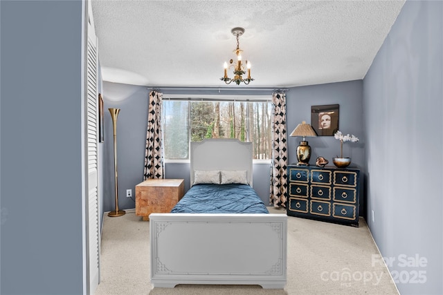 bedroom featuring an inviting chandelier and a textured ceiling