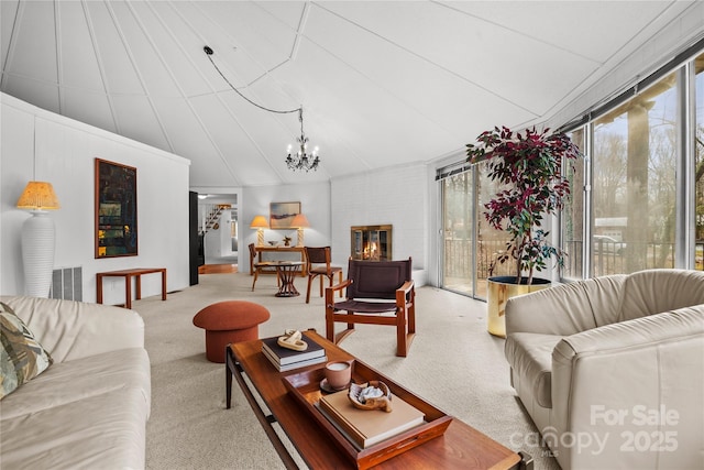 carpeted living room featuring a chandelier