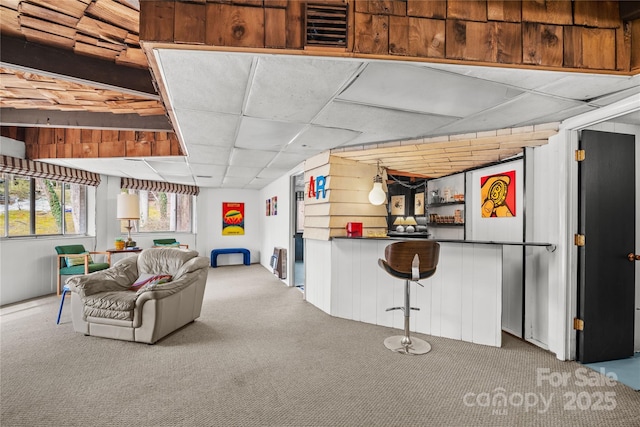 living room with a drop ceiling