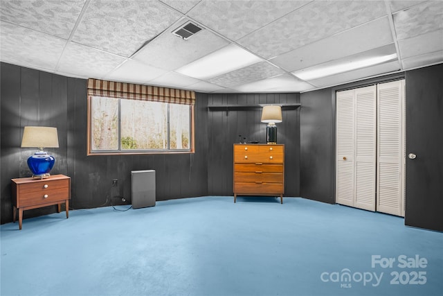 interior space featuring concrete flooring and wooden walls