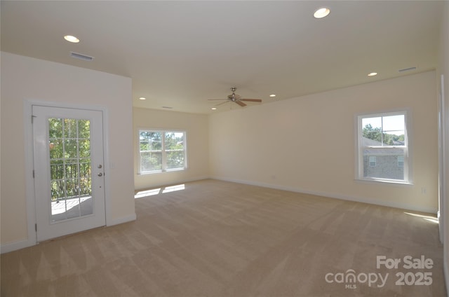 carpeted empty room featuring ceiling fan