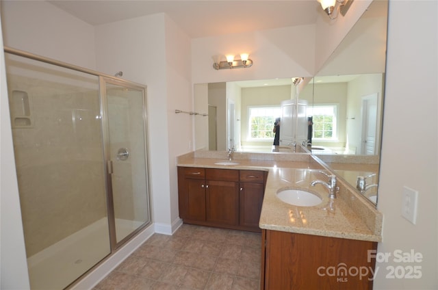 bathroom featuring an enclosed shower and vanity