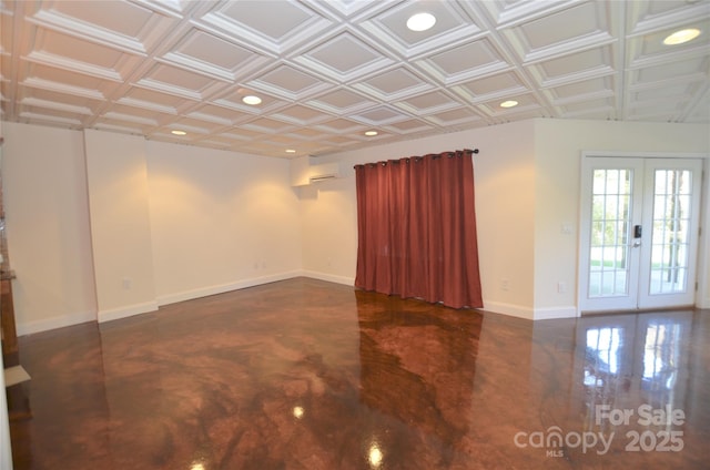 unfurnished room with a wall mounted AC and french doors