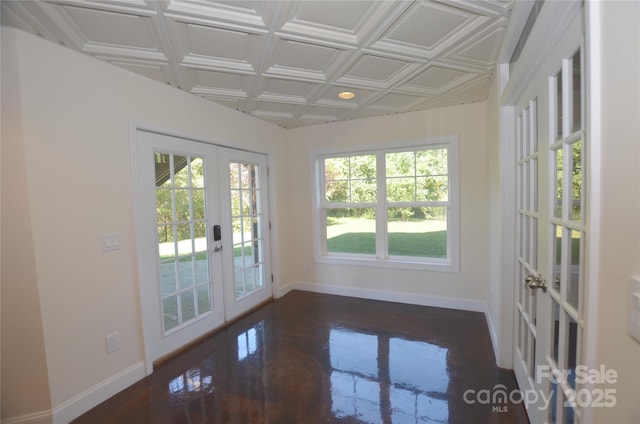 spare room featuring french doors and coffered ceiling