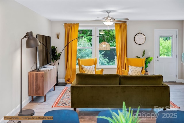 living room with wood-type flooring and ceiling fan