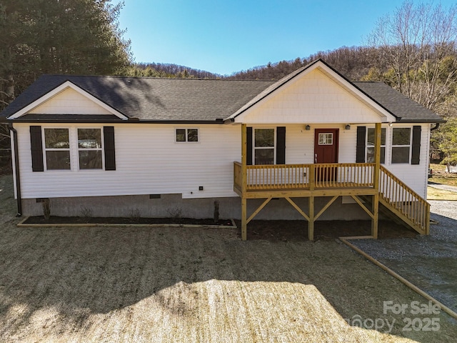 ranch-style house featuring crawl space, covered porch, and roof with shingles