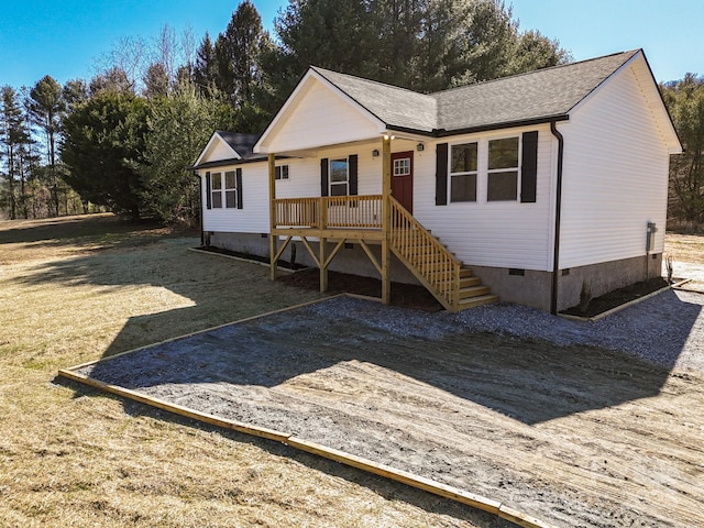 view of front of home with crawl space, a shingled roof, and stairway