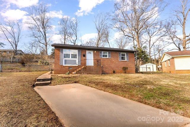 view of front of home with a shed and a front lawn