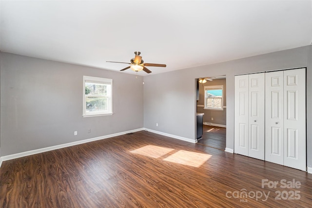 unfurnished bedroom with ceiling fan, a closet, and dark hardwood / wood-style floors