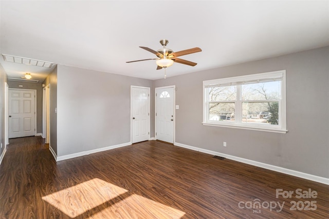 spare room featuring ceiling fan and dark hardwood / wood-style floors