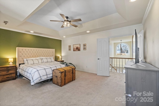 carpeted bedroom featuring crown molding, ceiling fan, and a tray ceiling