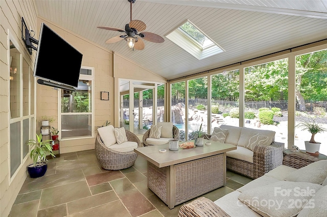 sunroom / solarium featuring lofted ceiling with skylight, a wealth of natural light, wooden ceiling, and ceiling fan