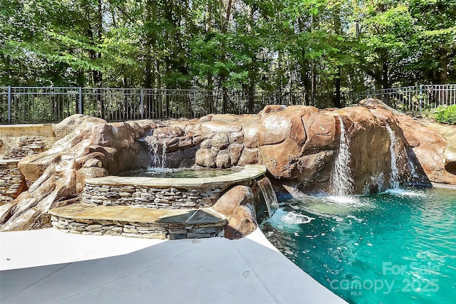 view of pool with pool water feature