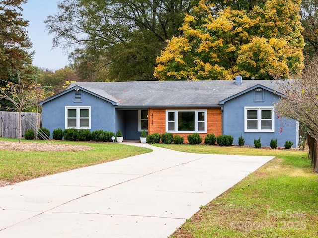 ranch-style home featuring a front yard