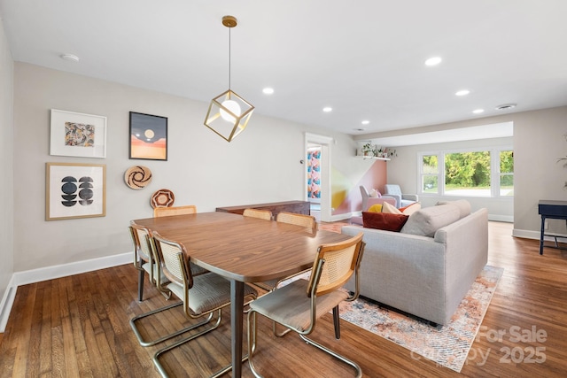 dining room with dark hardwood / wood-style flooring