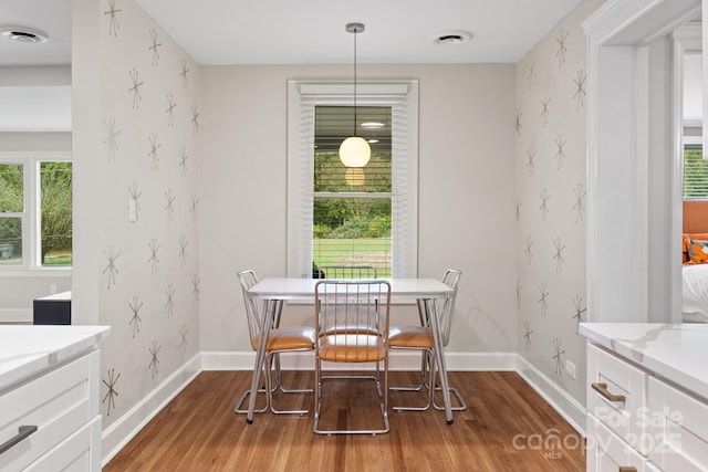 dining space with wood-type flooring and a wealth of natural light