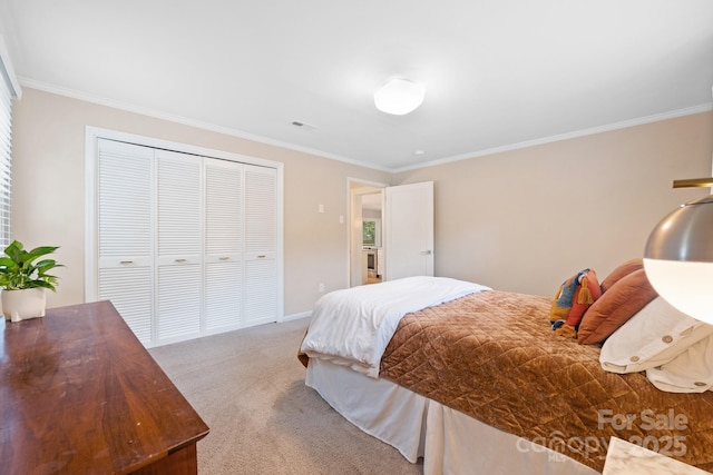 bedroom featuring a closet, ornamental molding, and carpet flooring